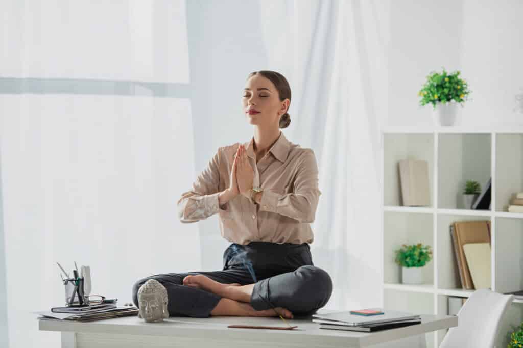 corporate businesswoman meditating in lotus pose w 2022 12 16 15 23 39 utc