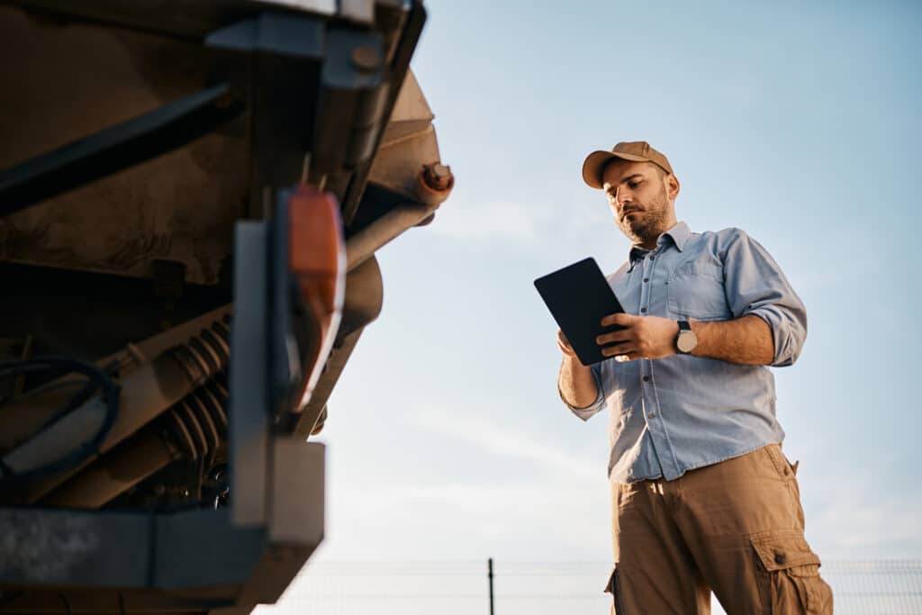 below view of truck driver using touchpad outdoors 2022 11 29 22 44 05 utc