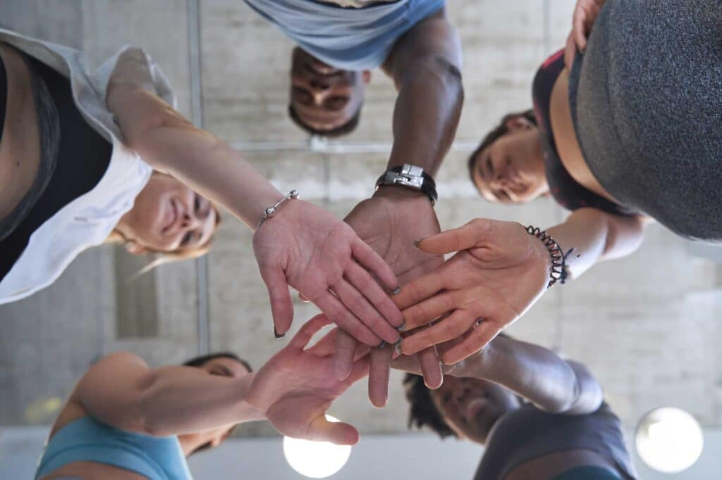 view from below of sporty people high five celebra 2023 09 01 21 07 14 utc