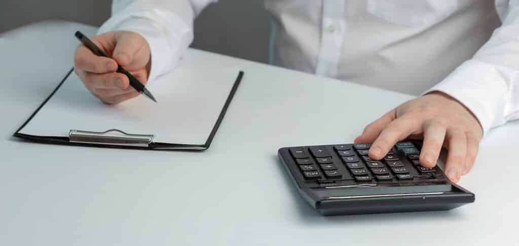 a man calculating income and expenses 2022 11 16 19 19 31 utc